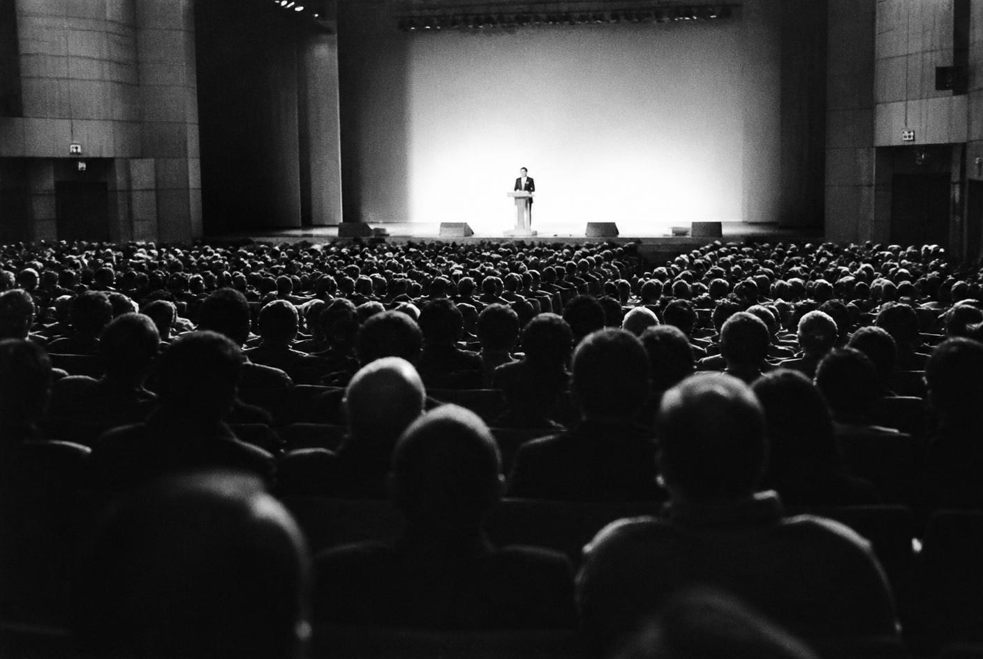 A packed auditorium during a conference talk
